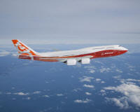 The new Boeing 747-8 Intercontinental soaring above the clouds during its first flight.

The airplane is painted in a new Sunrise livery of red-orange to honor many key Boeing customers whose cultures recognize these colors as symbols of prosperity and good luck. 